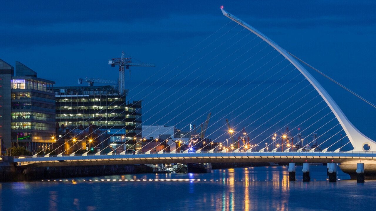 The river Liffey, the Samuel Beckett Bridge and the waterfront building near the Convention Center - Dublin city center in the Republic of Ireland.