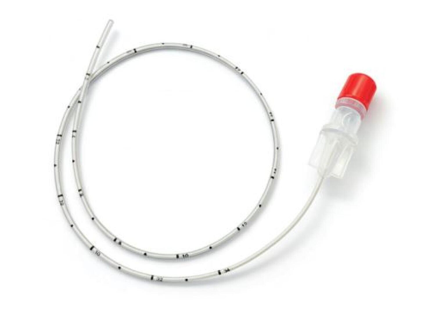 A medical catheter with black measurement markings, a transparent connector and a red cap, wound in a loose loop on a white background.