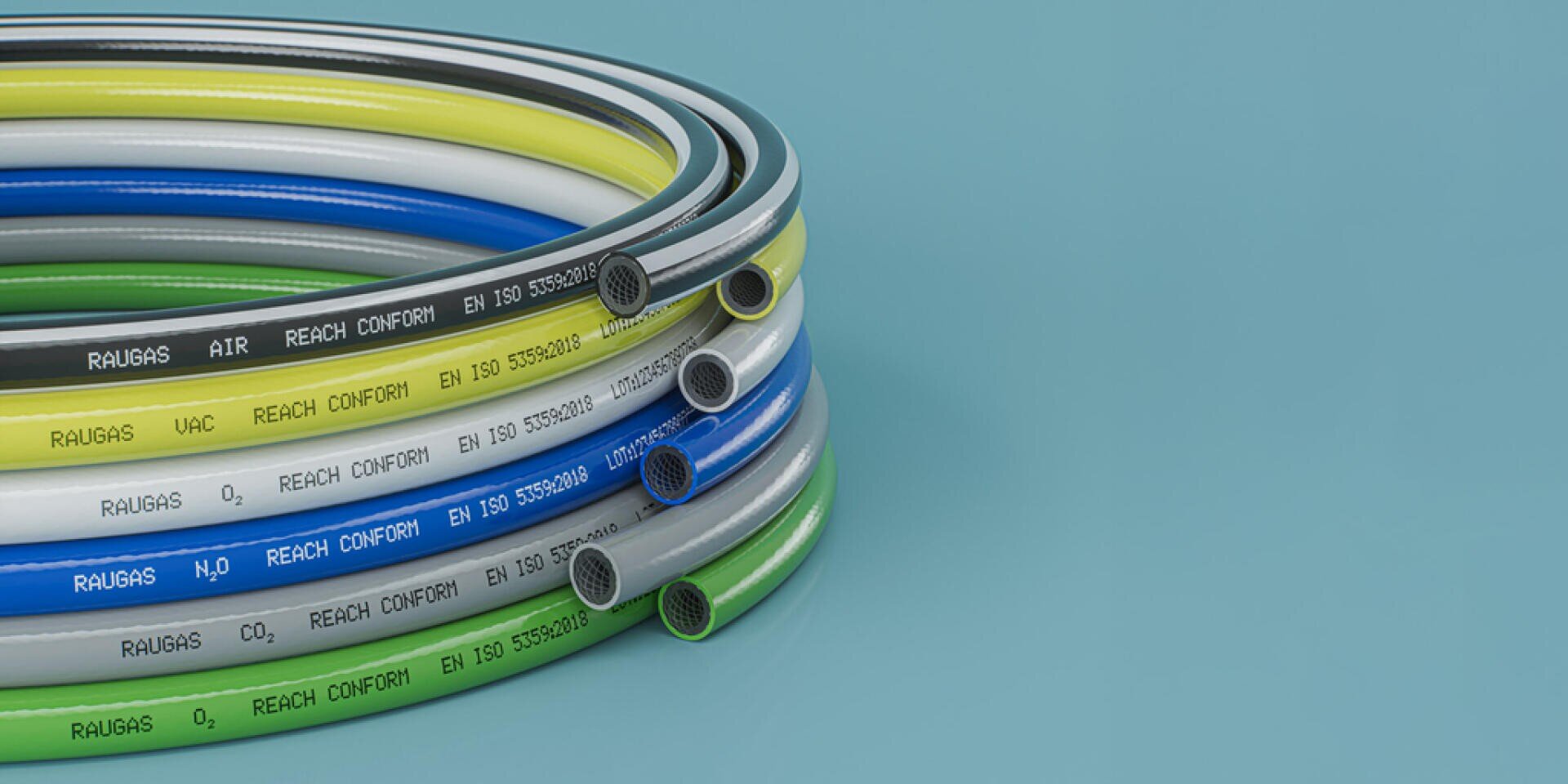 A stack of rolled-up, multi-colored plastic tubes labeled with various gases and standards and arranged on a smooth blue surface.