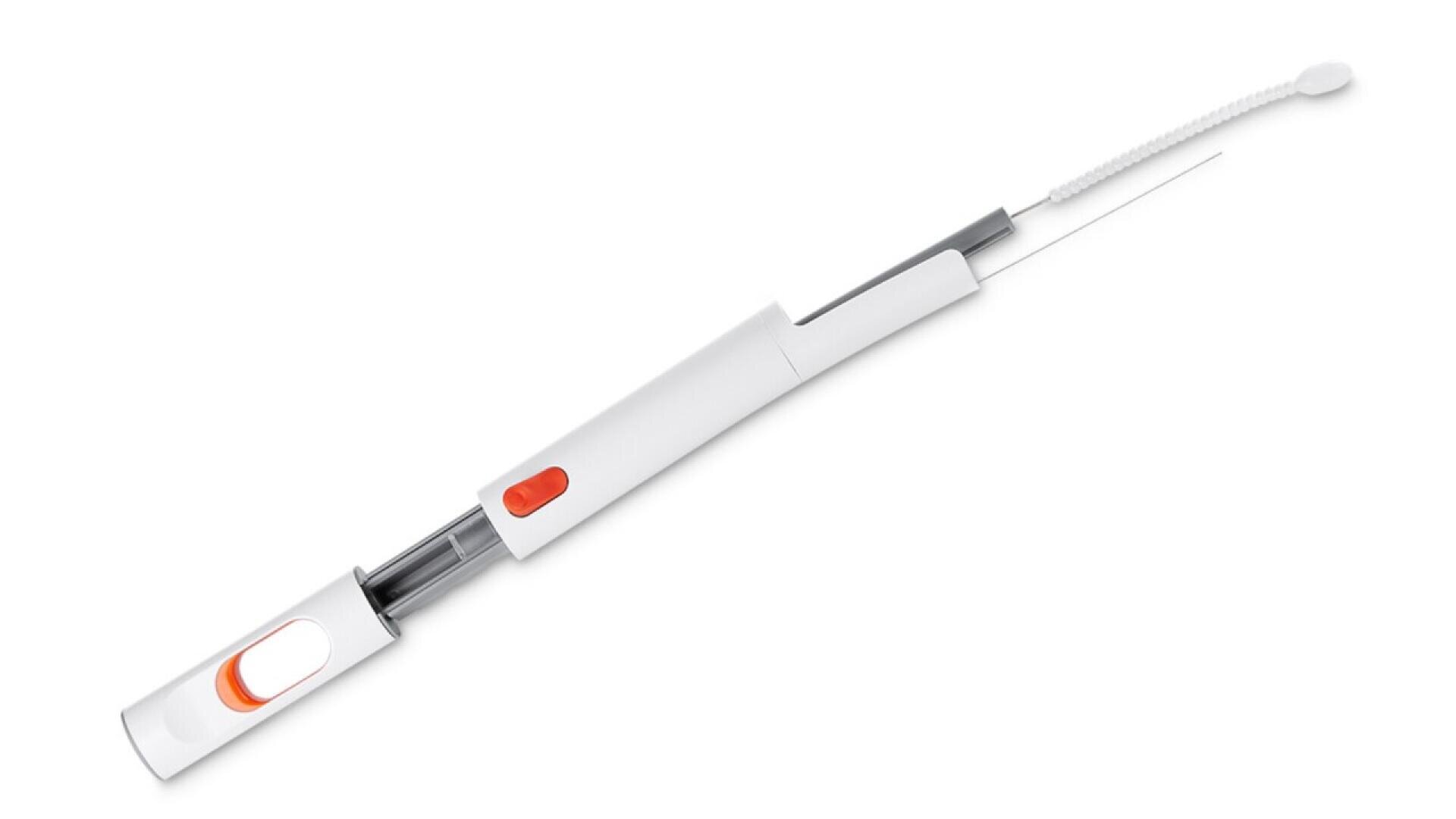 A white and gray pipe cleaner tool with an orange button and a long flexible cleaning brush extended from one end.