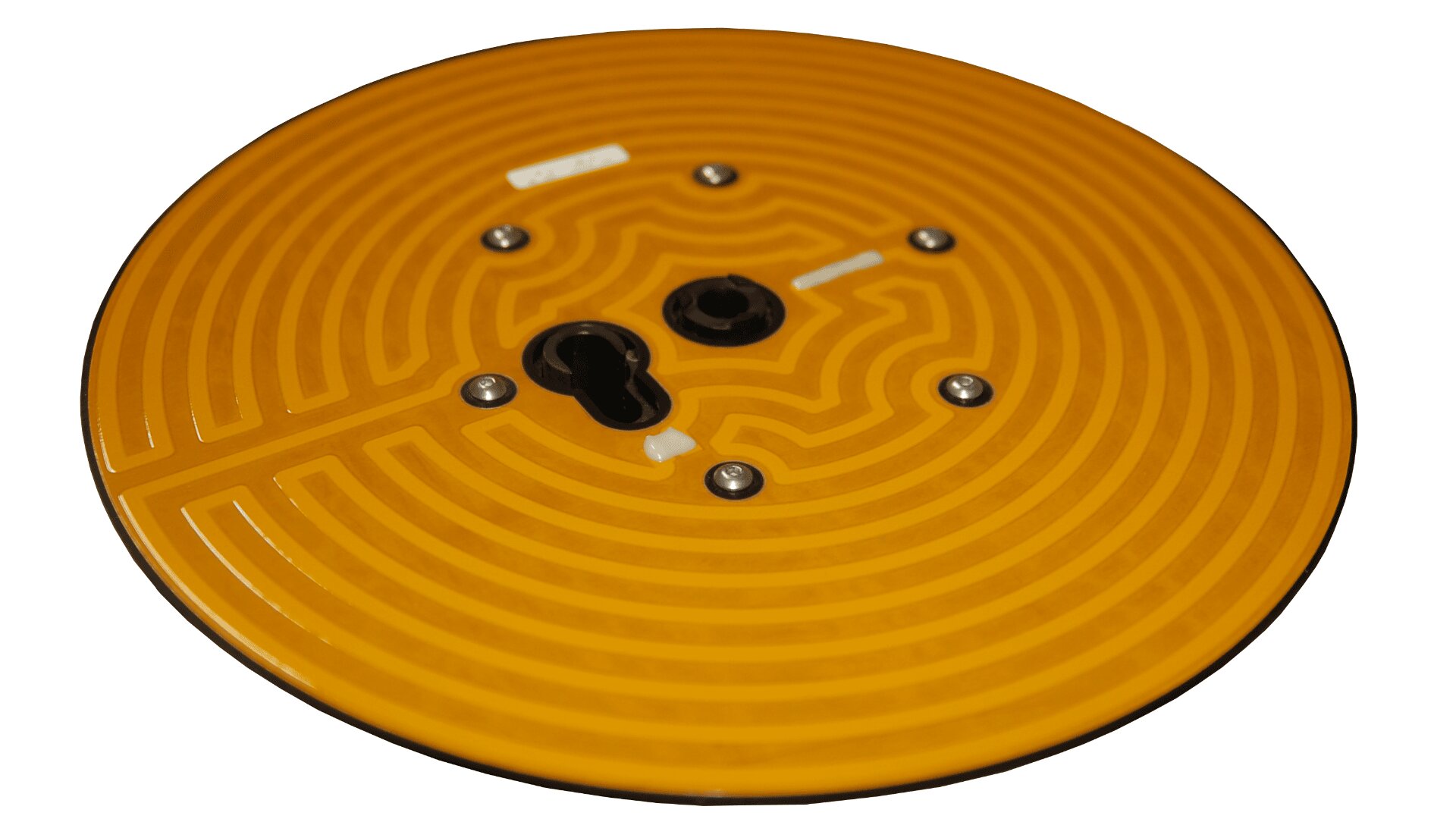 A round, flat, orange circuit board with a spiral pattern, several small metallic components, and a keyhole-shaped slot in the center.