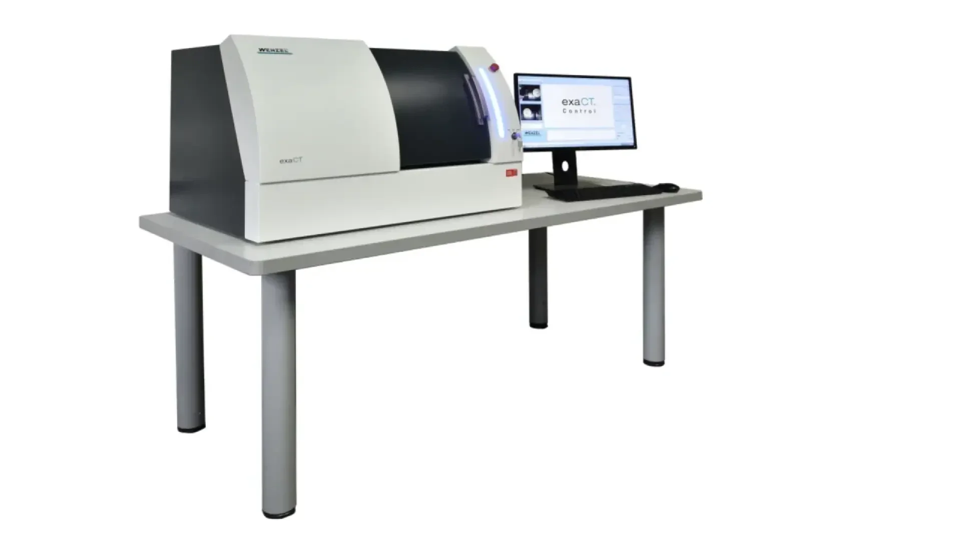 A lab instrument sits on a table next to a computer monitor and keyboard. The monitor displays software, and the device appears to be a benchtop analyzer or scanner, all set against a white background.