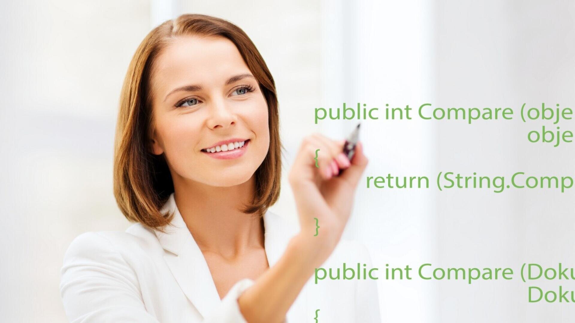 A woman in a white blazer smiles while writing code on a transparent screen. Green programming text is visible, including public int Compare and return (String.Com.