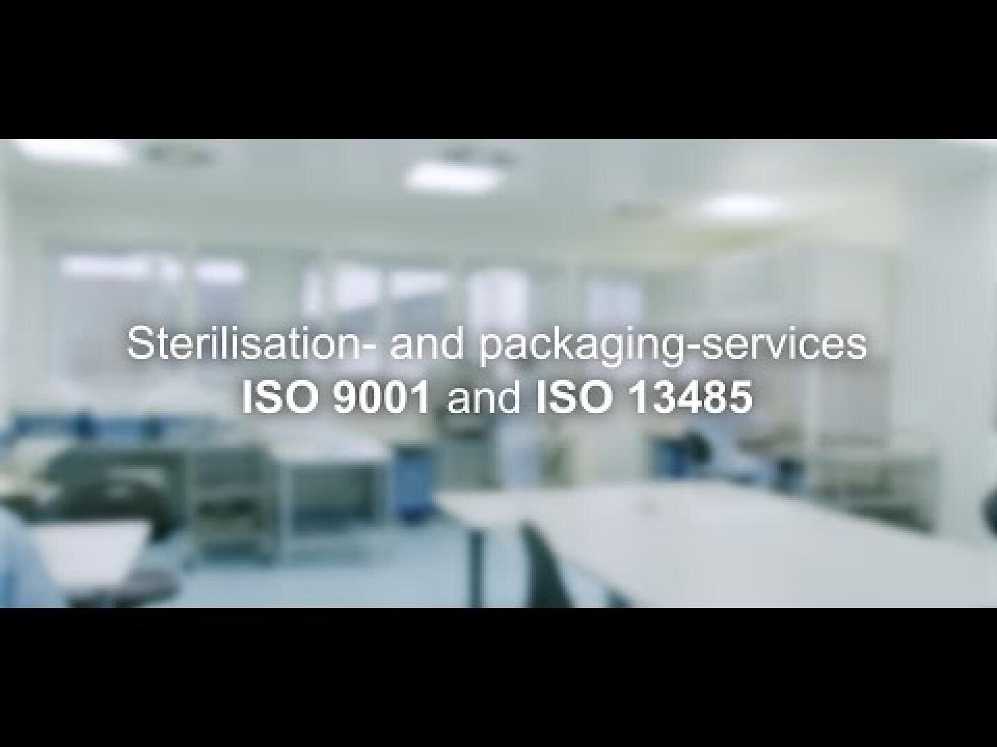 Blurry image of a clean, modern laboratory or medical facility with the text “Sterilisation- and packaging-services ISO 9001 and ISO 13485” displayed in the center.
