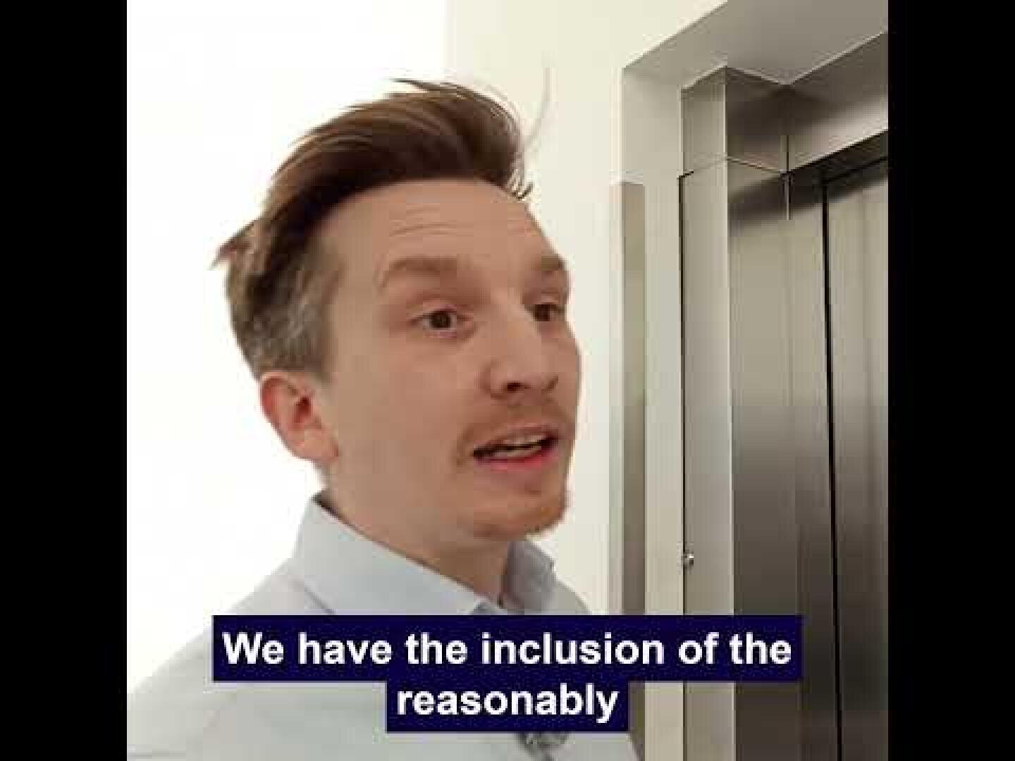 A man with light brown hair and a mustache stands near an elevator and speaks. The text on the picture reads: We have the inclusion of reasonable.