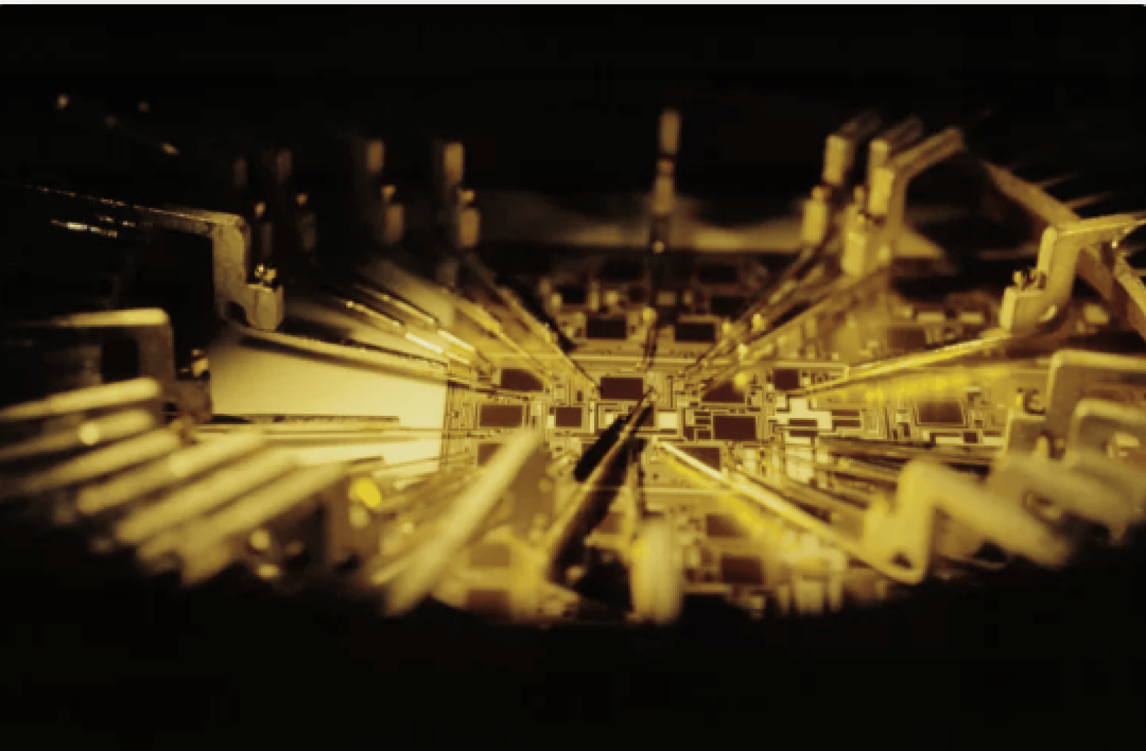 Close-up of a quantum computer processor with intricate gold circuits and components, illuminated by warm light highlighting the detailed and complex connections.