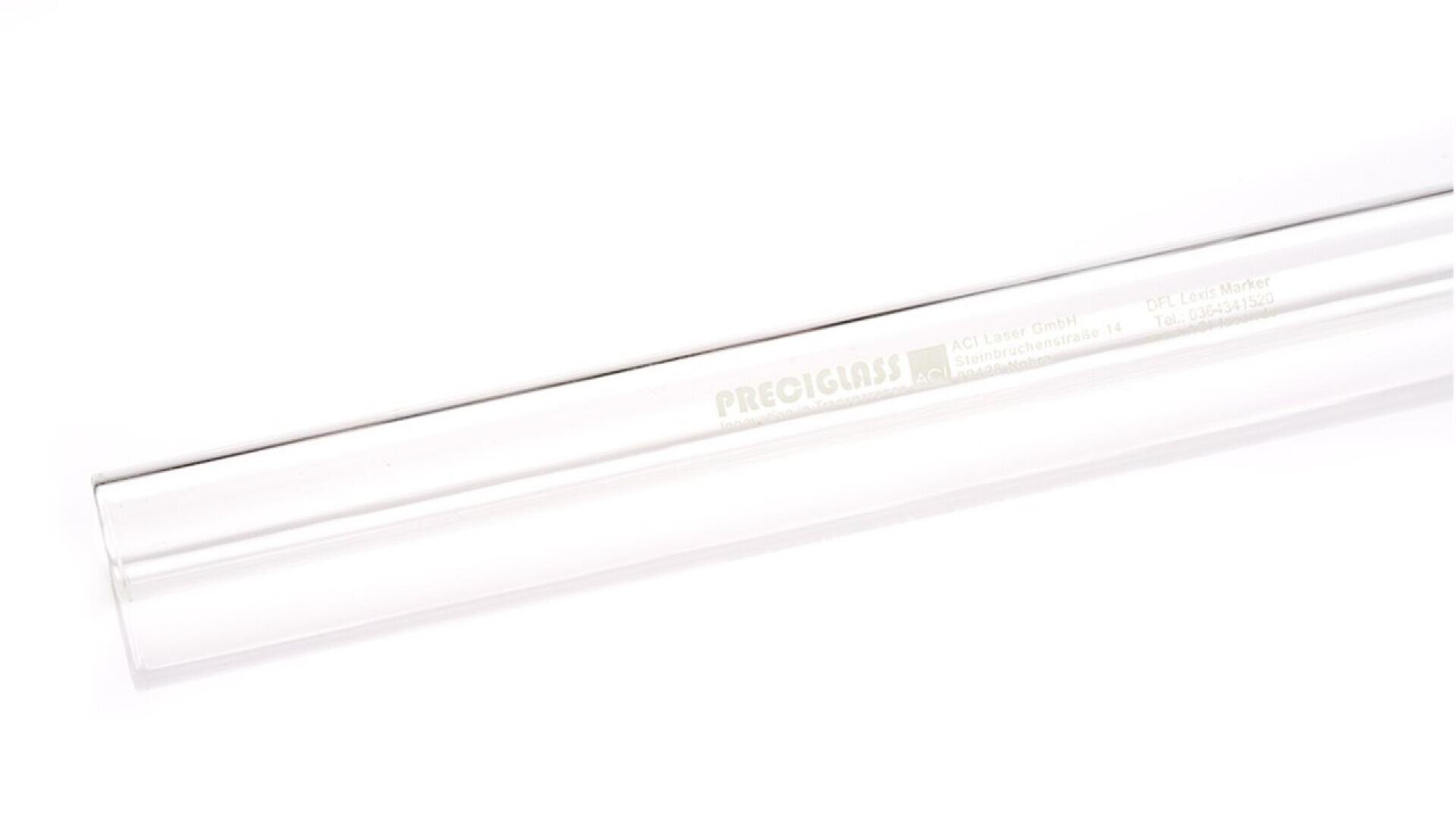 A clear, cylindrical glass tube with the word PRECIGLASS and other text faintly visible on its side, placed diagonally on a white background.