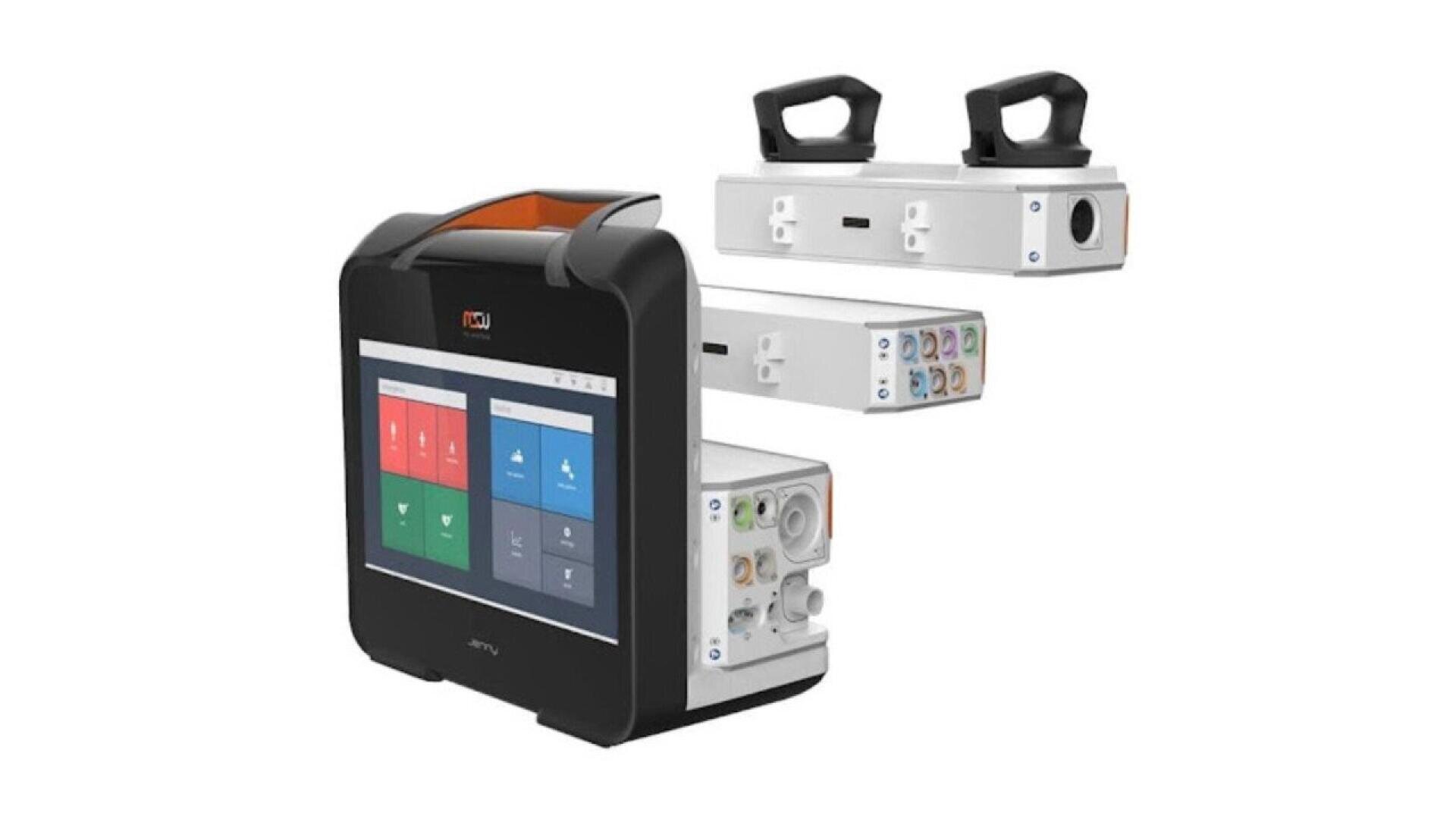 A medical device with a large touch screen and detachable modular units, each with various ports and handles, displayed against a white background.