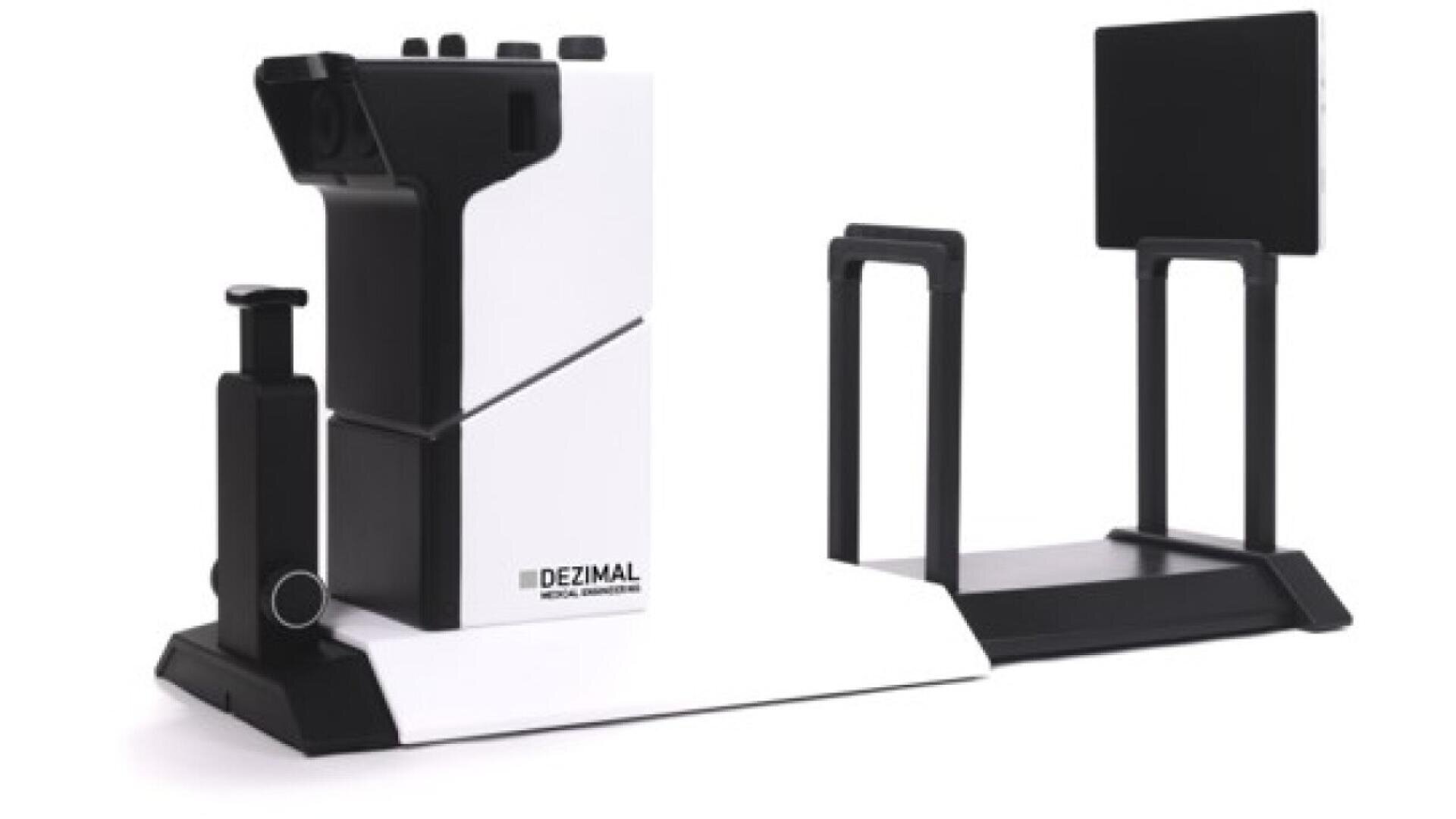 A sleek, modern medical device with a white and black design, labeled DEZIMAL, featuring a handheld scanner on a base and a separate rectangular screen mounted on a stand.