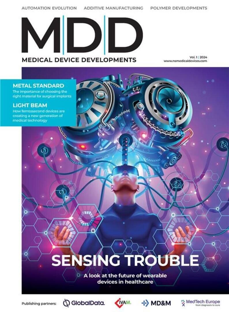 A futuristic magazine cover shows a person wearing a high-tech headset, surrounded by digital hexagons and sensors. The title reads “Sensing Trouble: A look at the future of wearable devices in healthcare.”.