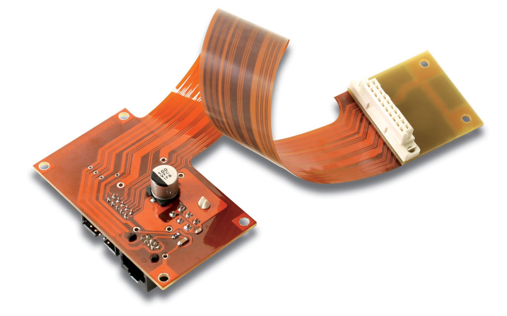 A red printed circuit board with electronic components is connected by a flexible brown flat ribbon cable to a second, smaller yellowish circuit board with a white connector, all on a white background.