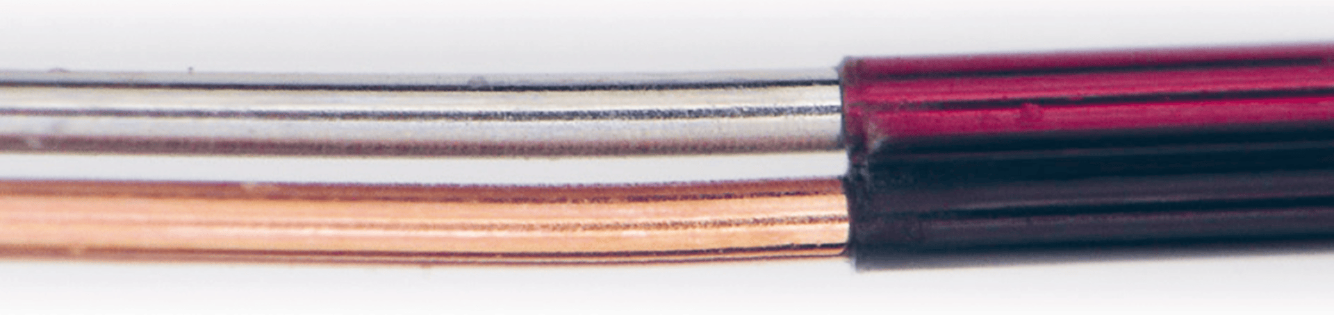 Close-up image of two parallel wires: one silver-colored and one copper-colored, both partially covered by dark red and black insulation on the right side.