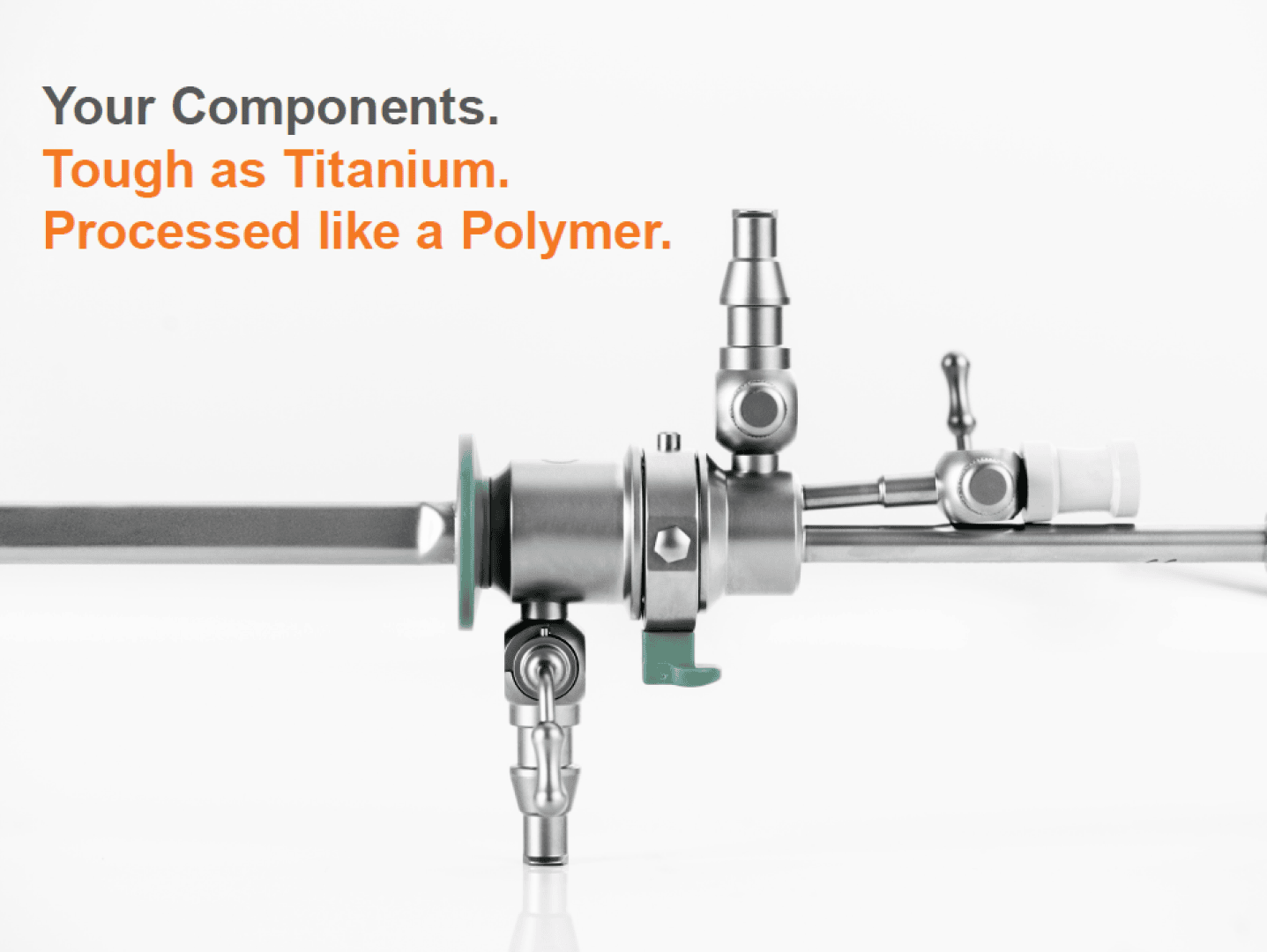 A medical metal part with valves and connections is shown on a white background. The text reads: Your components. Tough as titanium. Processed like a polymer.