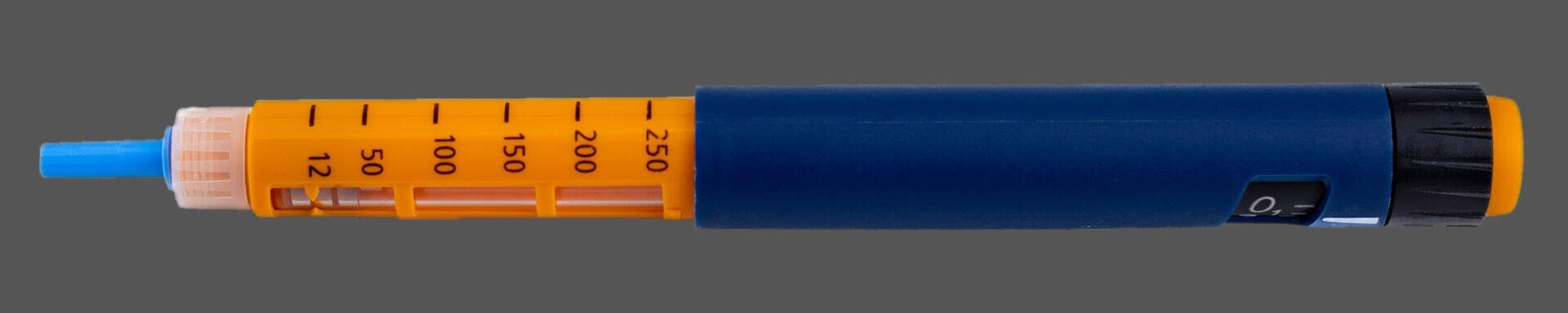An insulin pen with an orange dose selector, blue body, and a visible dosage window, photographed against a plain gray background.
