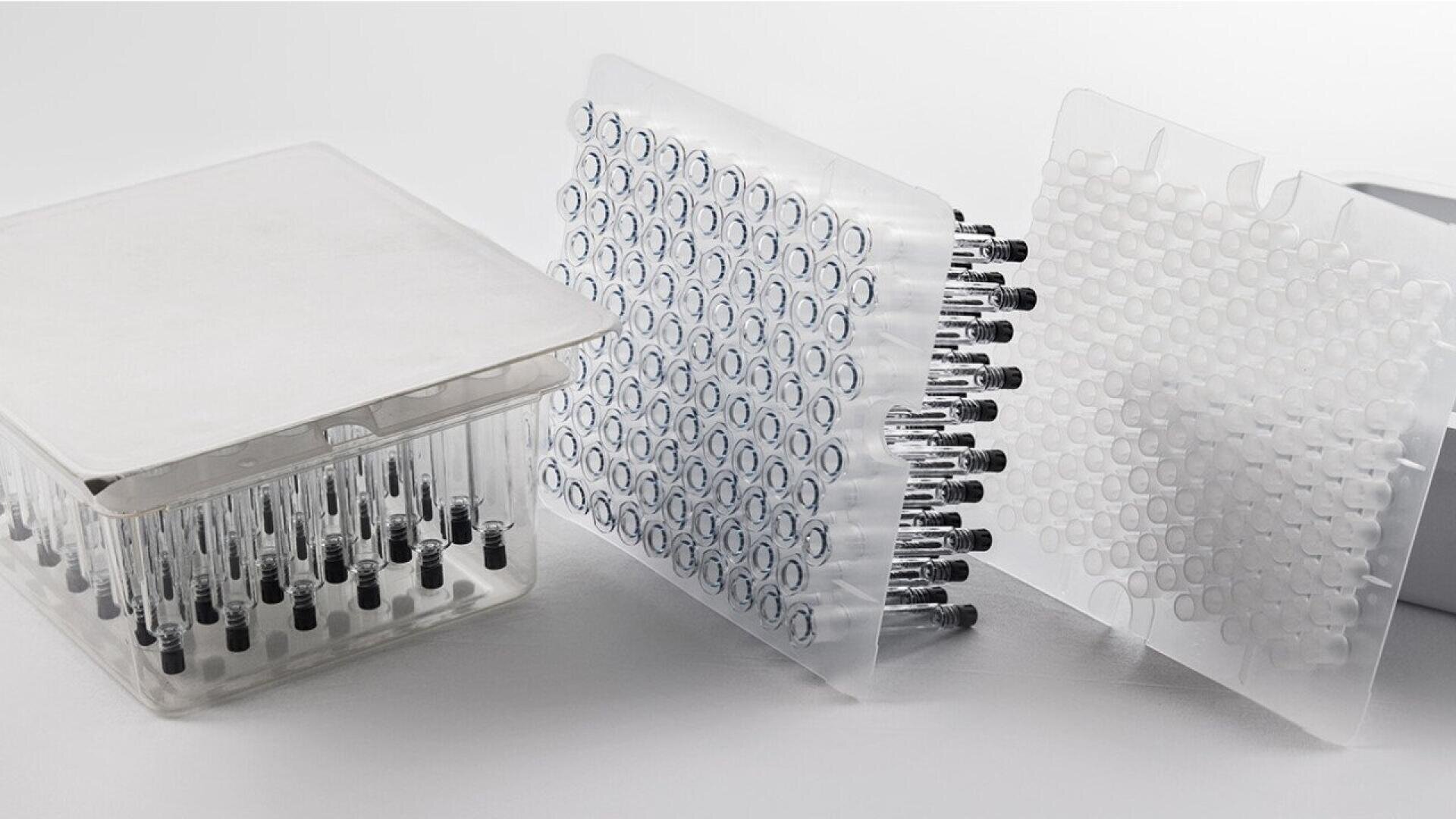 A set of pre-filled syringes arranged vertically in clear plastic packaging trays, with each tray holding multiple syringes, displayed on a light background.