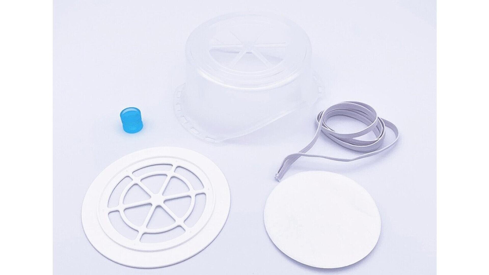 A transparent plastic container, a blue cap, a white circular vent, a white round filter, and a gray strap are arranged on a white background.