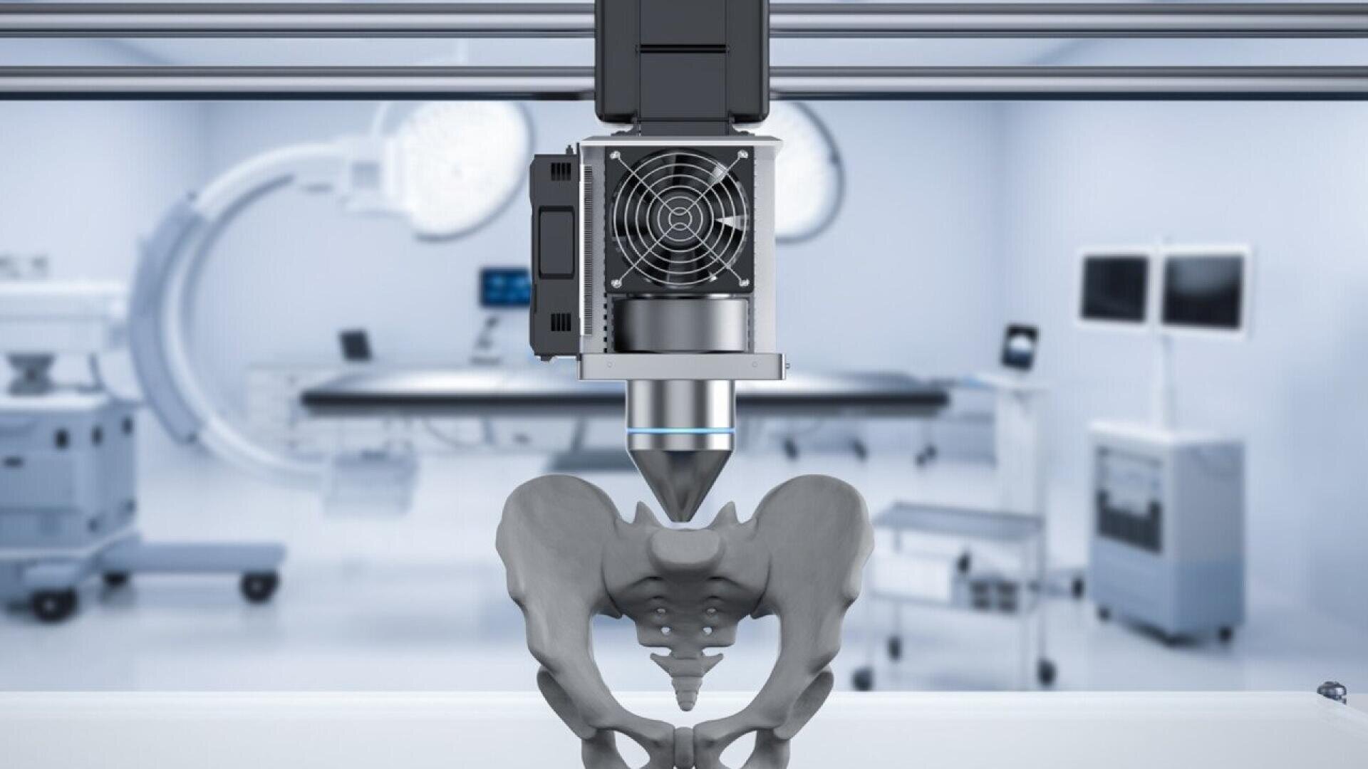 A 3D printer creates a model of a human pelvis in a modern medical lab, with hospital equipment and monitors visible in the blurred background.