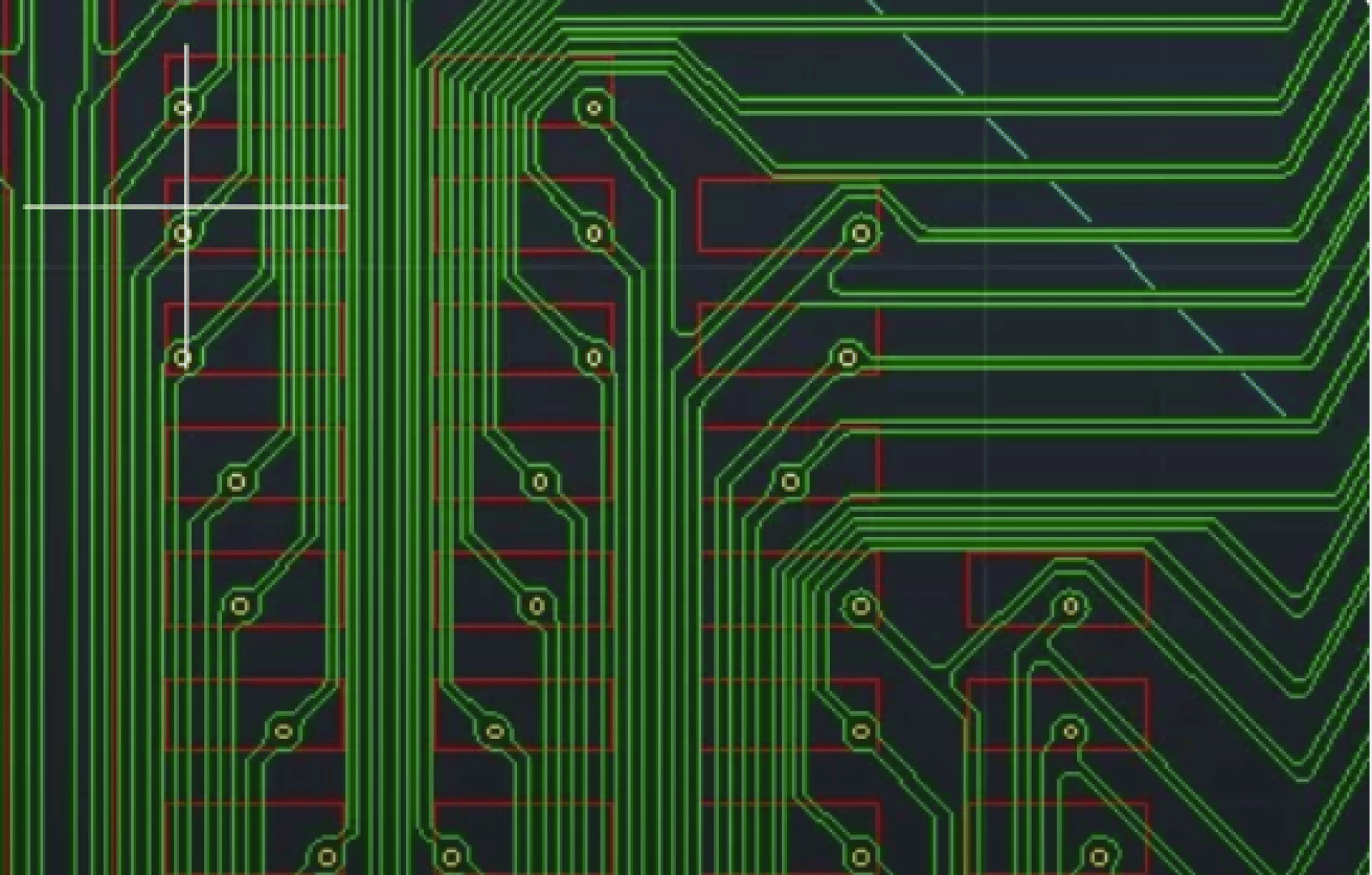 Close-up of a computer circuit board design, showing intricate green pathways and nodes with red outlines on a dark background, representing electronic connections and components.