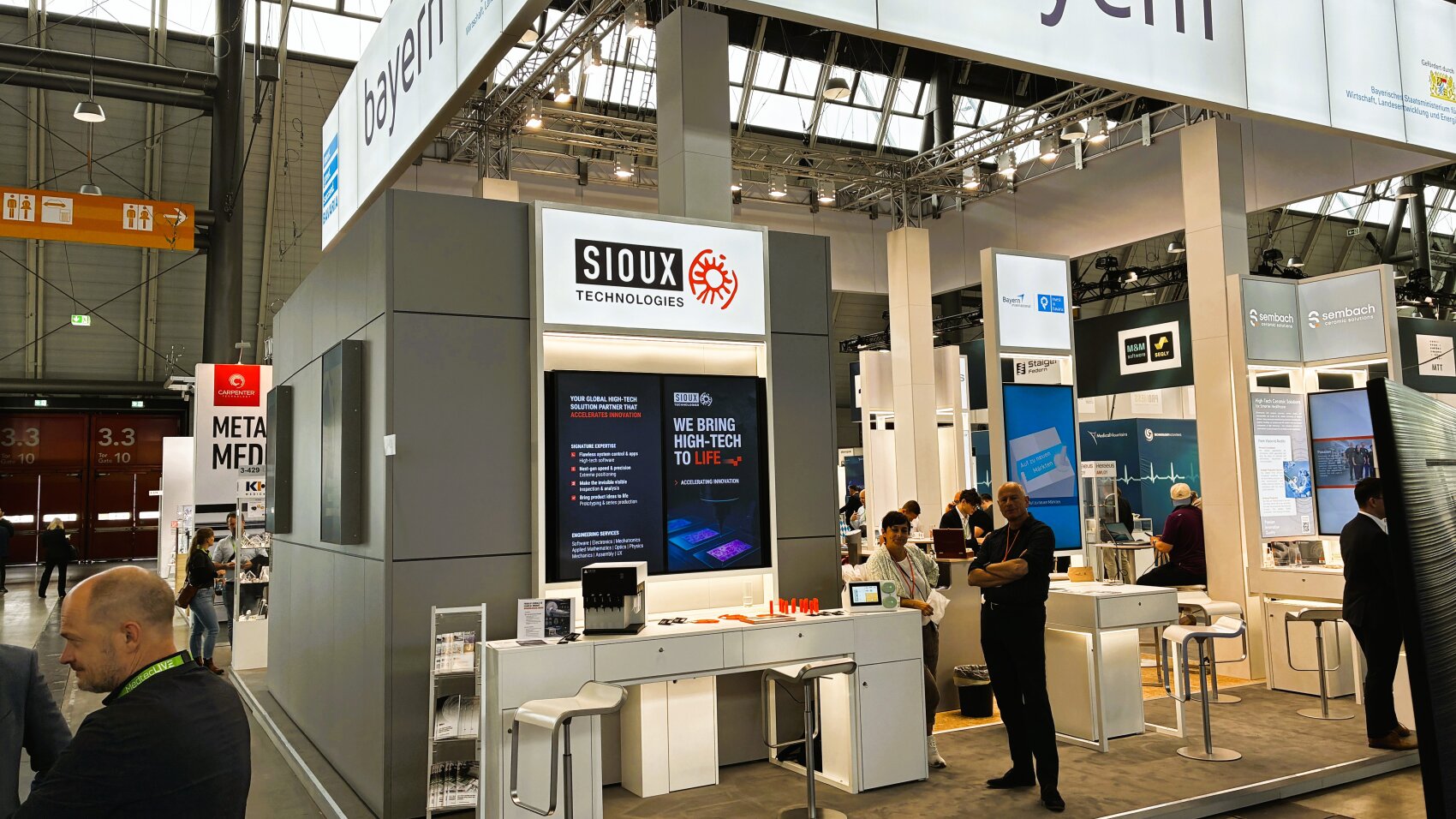 Sioux Technologies: Full-Stack-Entwicklung für CE-zertifizierte Medizingeräte  Vom Elektrophysiologie-Signal zum marktreifen Fetalmonitor – so lässt sich der Entwicklungsweg beschreiben, den der Erlanger Erlanger Engineering-Dienstleister Sioux Technologies gemeinsam mit Nemo Healthcare gegangen ist und der auf der MedtecLIVE 2026 als zentrales Referenzprojekt gezeigt wurde:  Das Nemo Fetal Monitoring System (NFMS) erfasst nicht-invasiv und ohne Ultraschall die Herzfrequenz des Ungeborenen während Schwangerschaft und Geburt. Dazu werden am Bauch der Mutter sechs Elektroden des sogenannten Nemo Patch aufgebracht, die simultan maternales EKG, Uterusaktivität und fetale Herzaktivität als elektrophysiologische Signale ableiten.   Embedded-Medical-System digitalisiert Herzschlag  Aus technischer Sicht digitalisiert ein rauscharmer Verstärker mit nachgeschaltetem ADC die schwachen Biosignale und überträgt sie anschließend per Bluetooth an das Nemo-Basisgerät. Der eigentliche Algorithmus zur Signaltrennung – die Extraktion der fetalen Herzfrequenz aus dem überlagerten Mutter-Kind-Signal – läuft auf der Basisstation; als Prozessor ist ein NXP ARM-basierter Multi-Core-Mikrocontroller verbaut. Das fertige System ist CE-zertifiziert und wird inzwischen auch im Heimmonitoring eingesetzt.  Sioux verantwortete das vollständige elektronische, hard- und softwareseitige wie auch mechanische Design sowie die Prototypenerstellung. Hardwareseitig nutzt das Unternehmen Standardmodule von Toradex als Computing-Kern, die um kundenspezifisches Analog-Frontend, Schnittstellen und Sensorik auf einem integrierten PCB ergänzt werden – ein Hybridansatz, der Entwicklungszeit verkürzt und die regulatorische Dokumentation vereinfacht.   Das rund 1500 Mitarbeiter zählende niederländische Unternehmen mit Standort in Erlangen beschäftigt allein 1200 Ingenieure und bietet je nach Bedarf Komplettentwicklung, modulare Unterstützung in Elektronik oder Embedded-Software sowie Interim-Engineering für Startups bis hin zu Konzernen wie Siemens Healthineers oder Philips Healthcare.